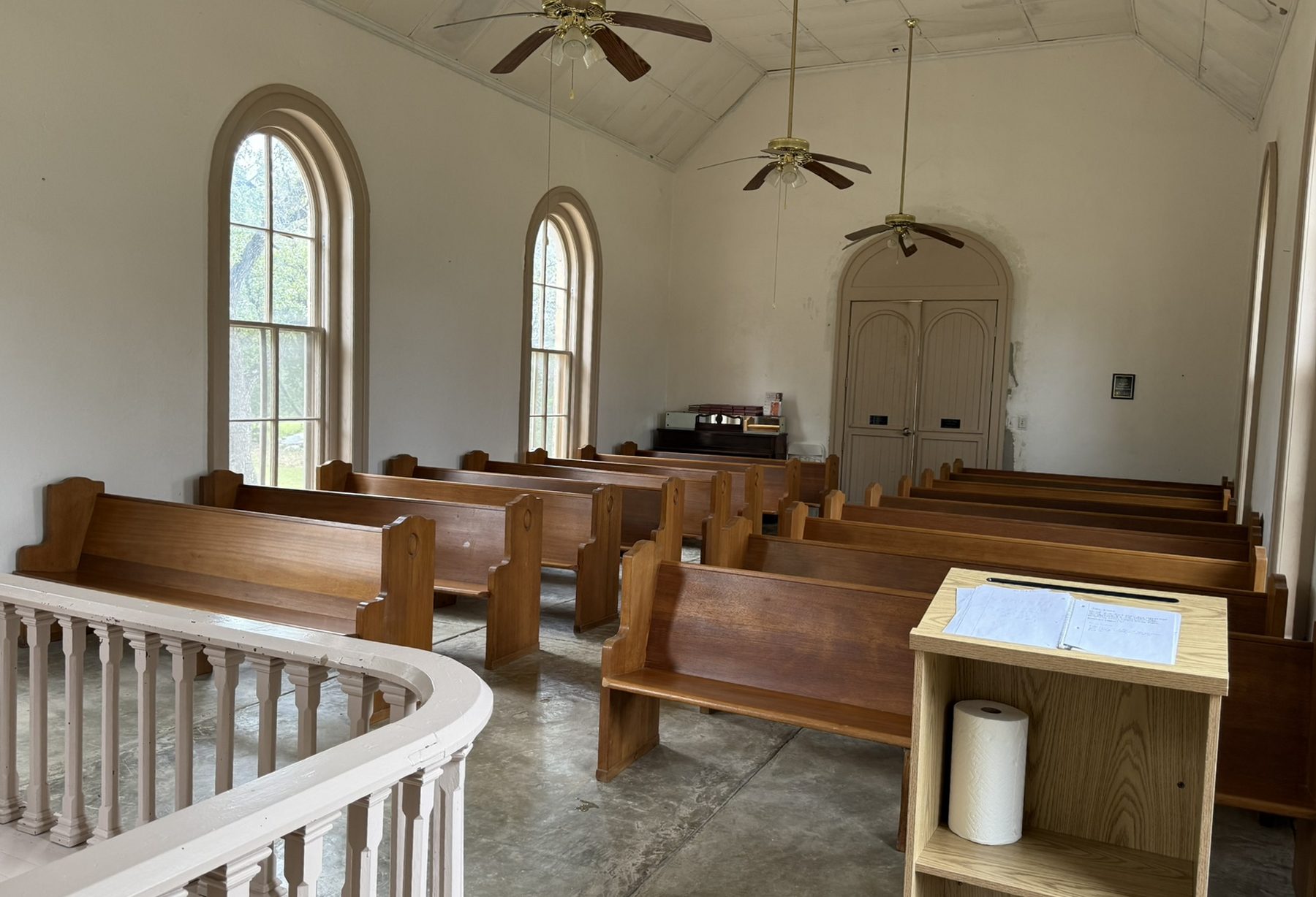 Interior of Polly's Chapel with wooden pews and tall windows