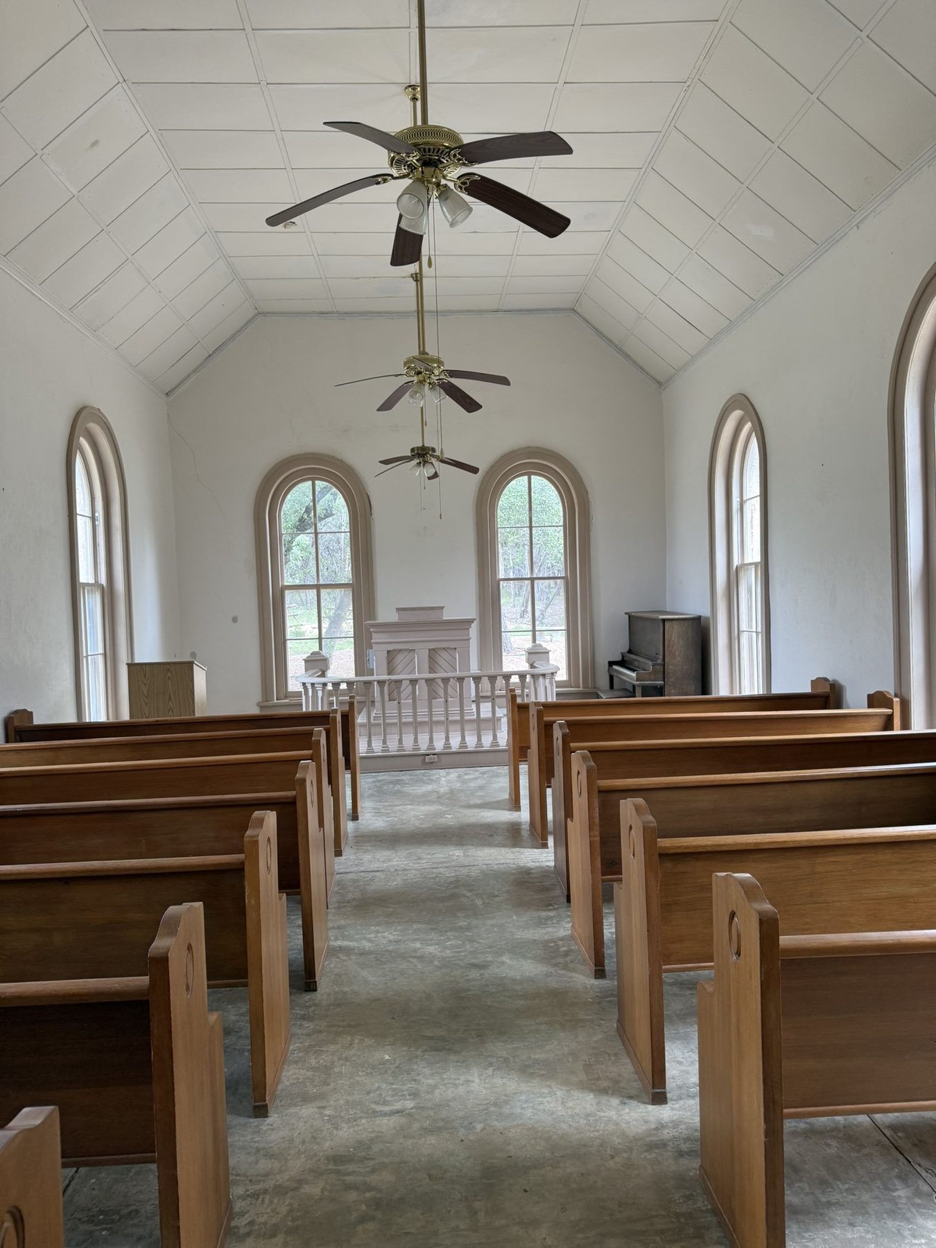 The aisle of Polly's Chapel leading to the raised wooden pulpit
