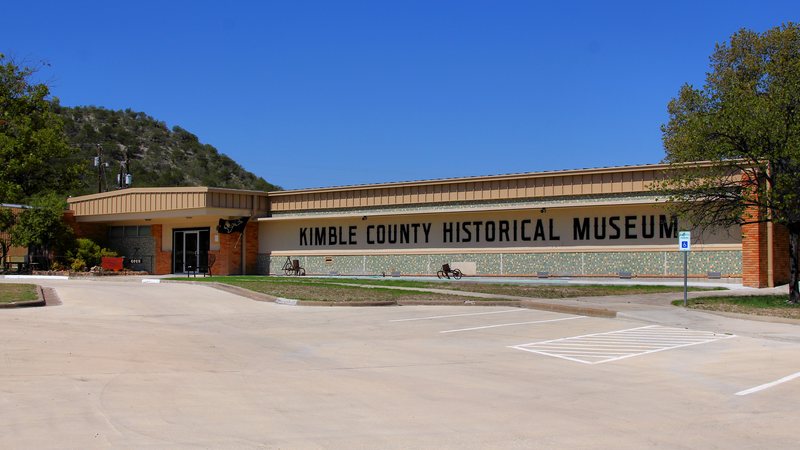 The Kimble County Historical Museum building in Junction, with hills behind it
