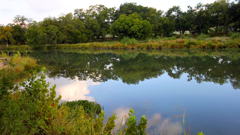 The South Llano River reflecting trees and sky at South Llano River State Park near Junction